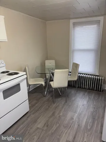 a view of a room with a wooden floor and a chair