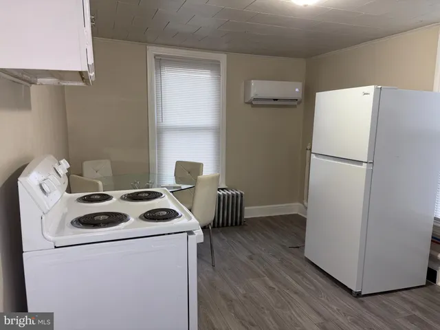 a kitchen with a refrigerator a stove top oven a sink and dishwasher