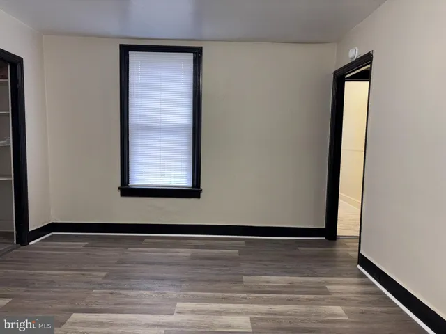 a view of a room with wooden floor
