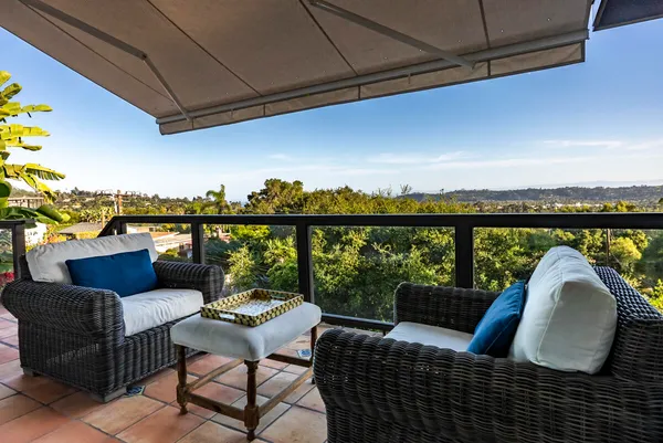 a couple of chairs sitting in patio of a house