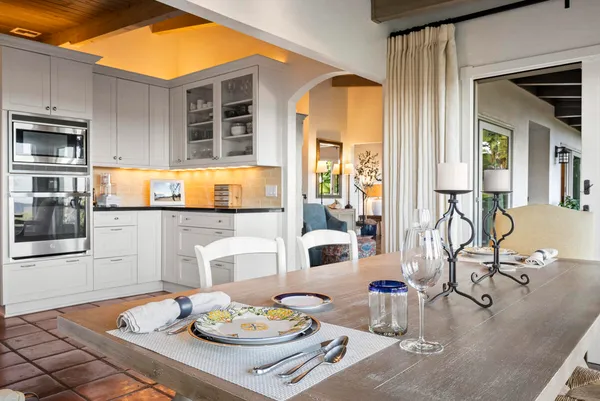 a bedroom with a bed and a large window with the outer view