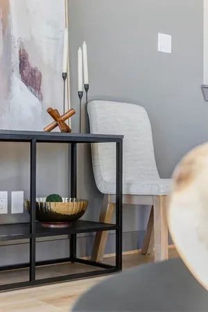 a living room with chairs and a table