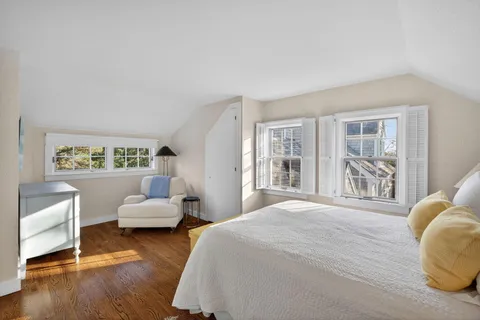 a spacious bedroom with a bed and a large window