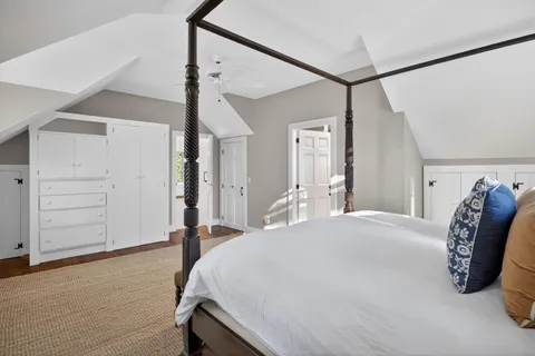 a bed room with a bed and a chair