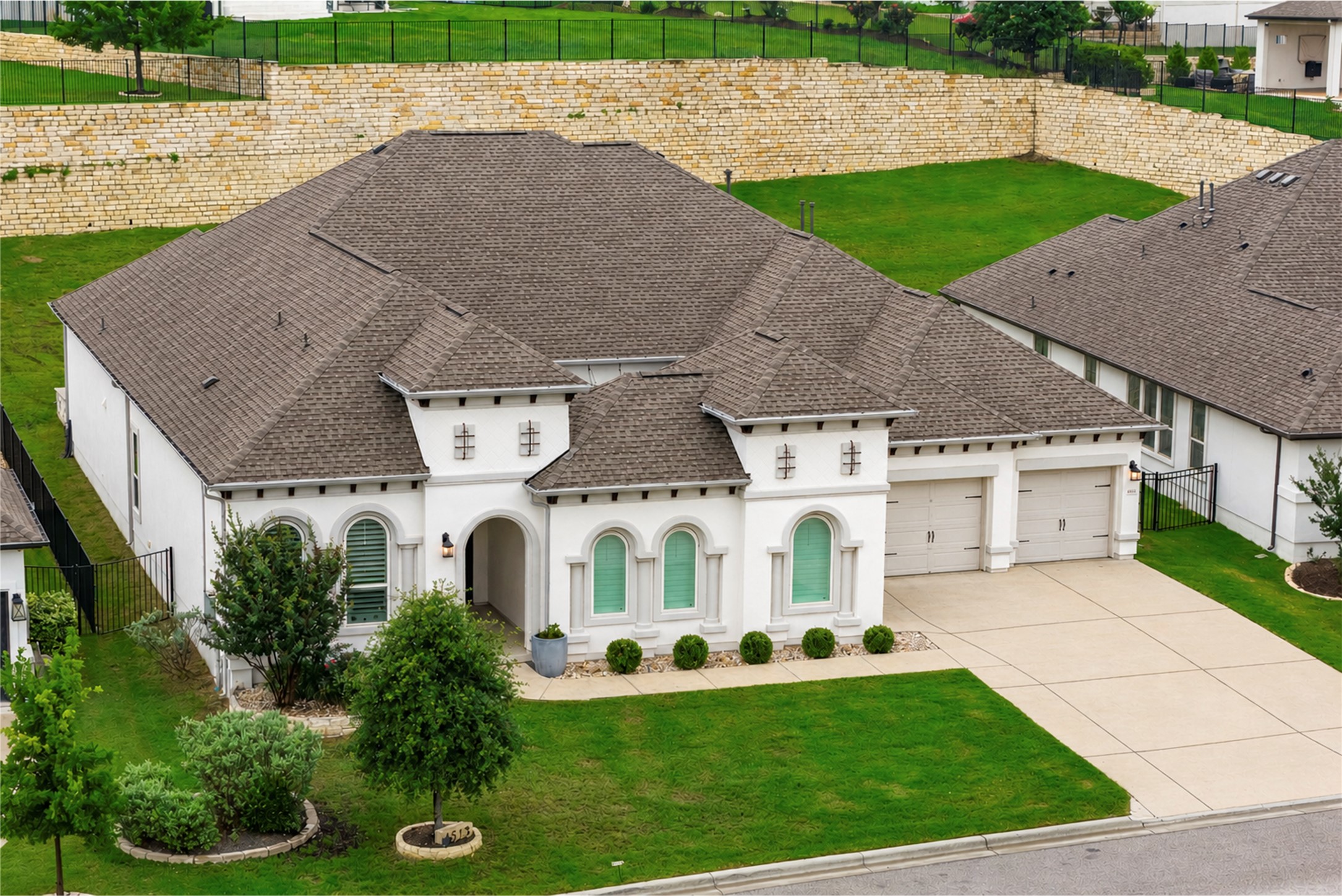4513 Vieste View Leander, TX 78641 - Photo 40 of 40 Contemporary stucco exterior with arched windows and beautifully landscaped garden