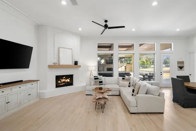 a living room with furniture a fireplace and a flat screen tv