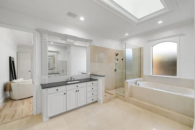 a bathroom with a granite countertop sink a toilet a mirror and bathtub