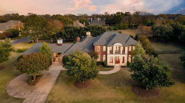 an aerial view of a house with a yard basket ball court and outdoor seating