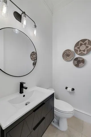 a bathroom with a sink a toilet and a mirror