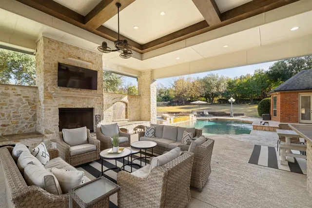 a outdoor living space with patio furniture and a fireplace