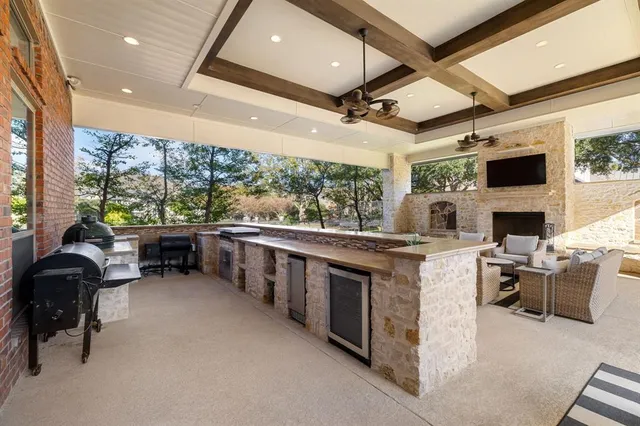 a open kitchen with stainless steel appliances granite countertop a stove and a refrigerator