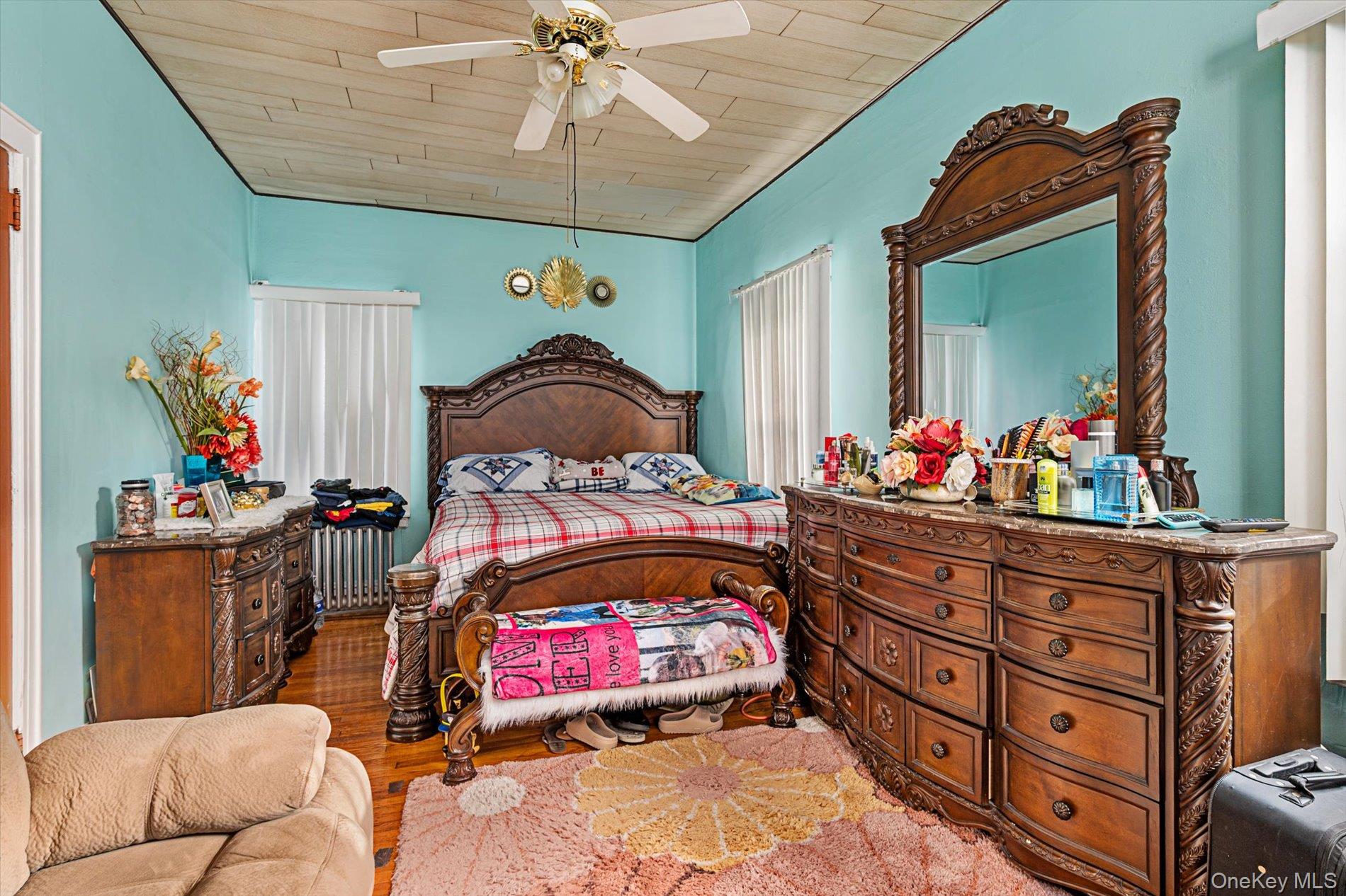 133-15 231st Street Queens, NY 11413 - Photo 13 of 22 a bedroom with a bed and a chandelier