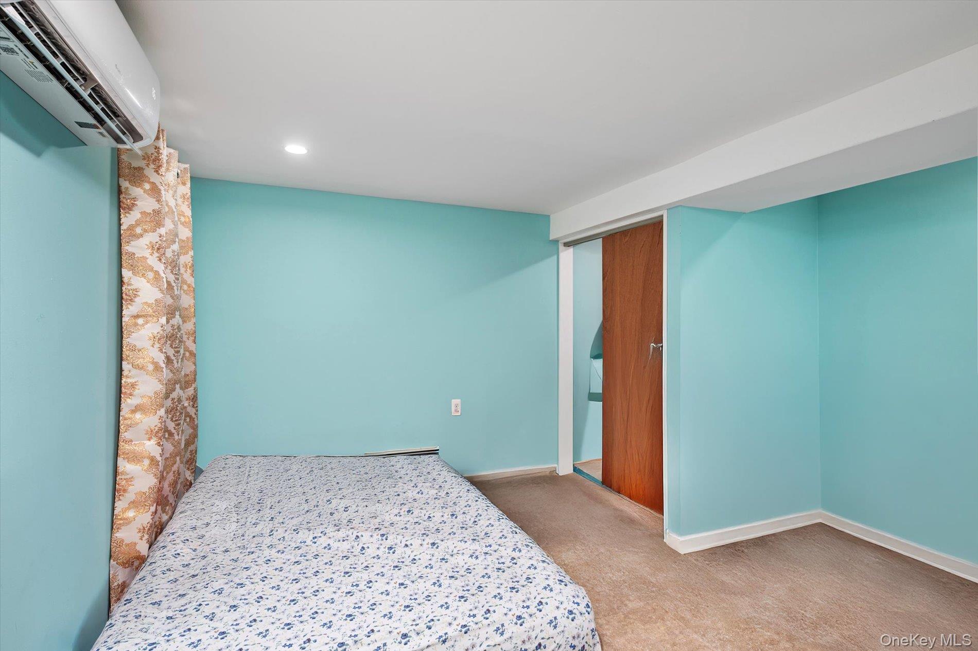 133-15 231st Street Queens, NY 11413 - Photo 16 of 22 a bedroom with a bed and a window