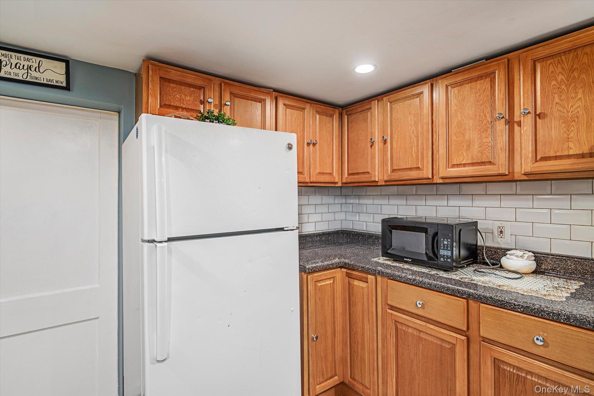 133-15 231st Street Queens, NY 11413 - Photo 17 of 22 a white refrigerator freezer sitting in a kitchen