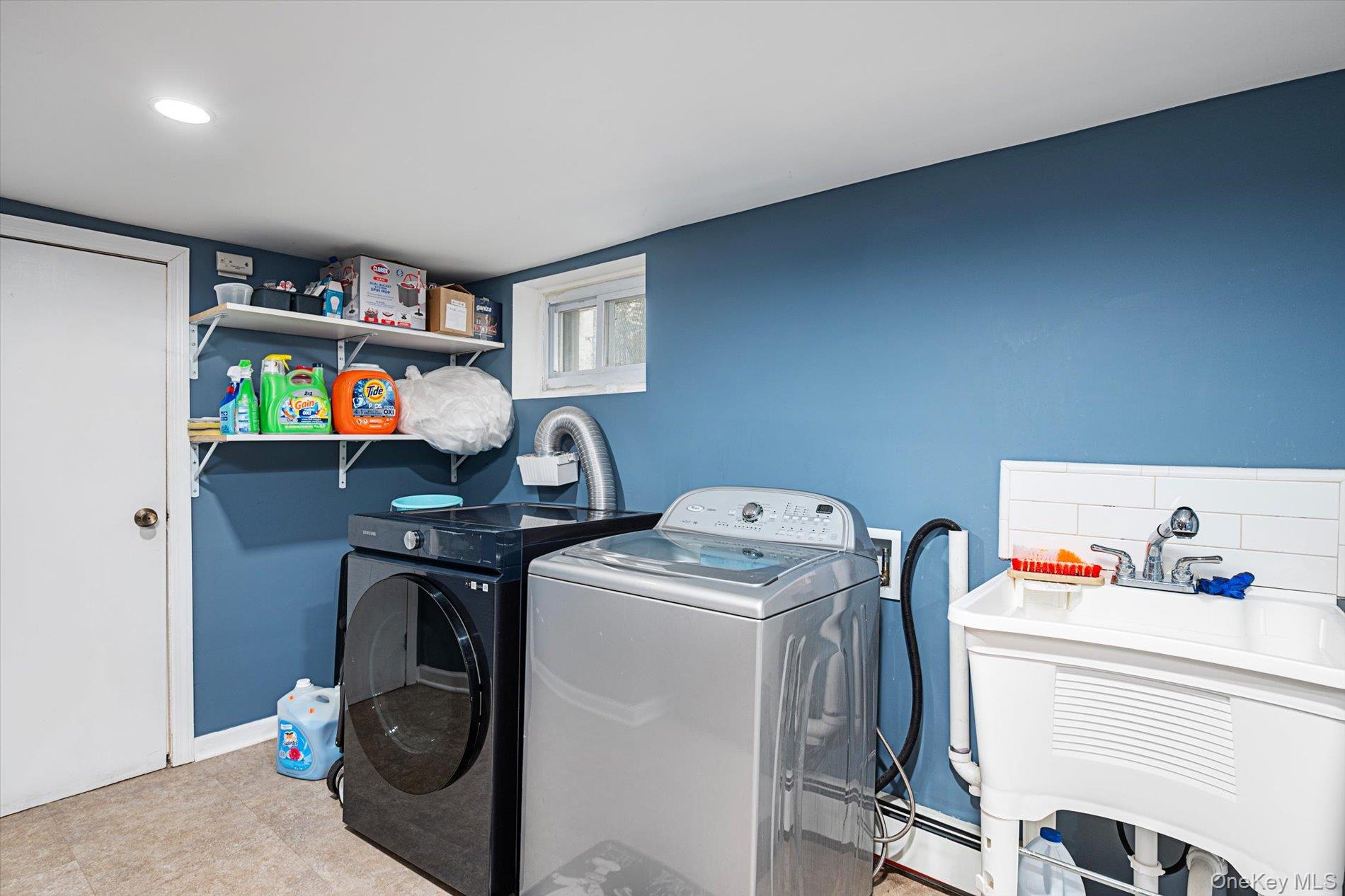 133-15 231st Street Queens, NY 11413 - Photo 18 of 22 a utility room with dryer and washer