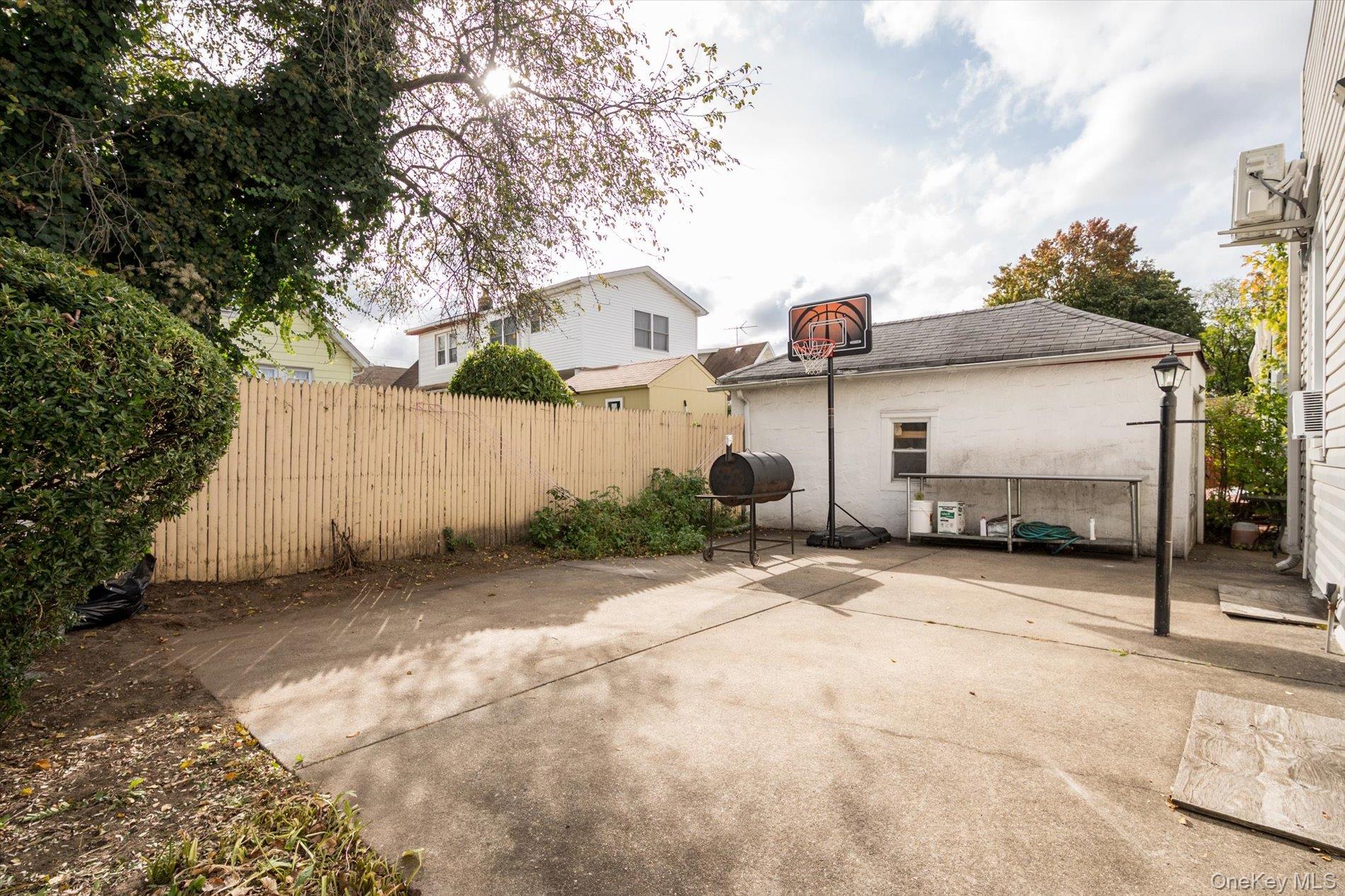 133-15 231st Street Queens, NY 11413 - Photo 19 of 22 a front view of a house with a yard and garage