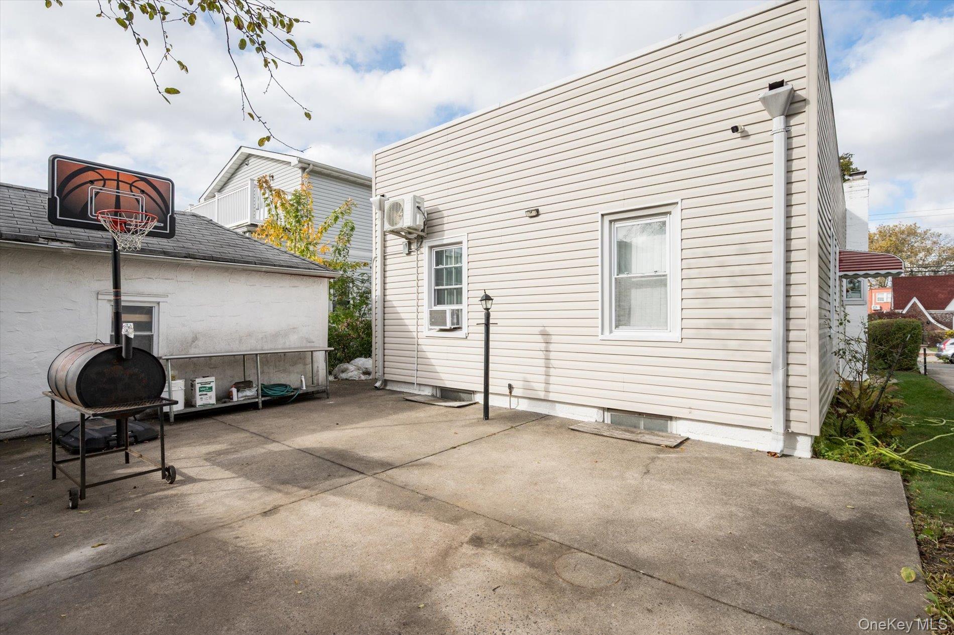 133-15 231st Street Queens, NY 11413 - Photo 20 of 22 a backyard of a house with barbeque oven table and chairs