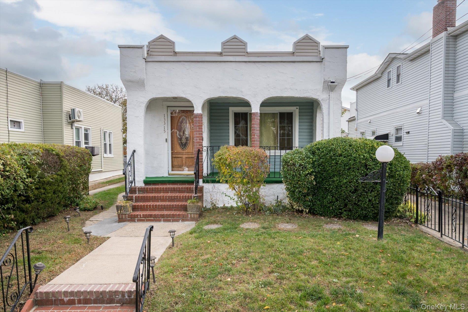 133-15 231st Street Queens, NY 11413 - Photo 2 of 22 a front view of a house