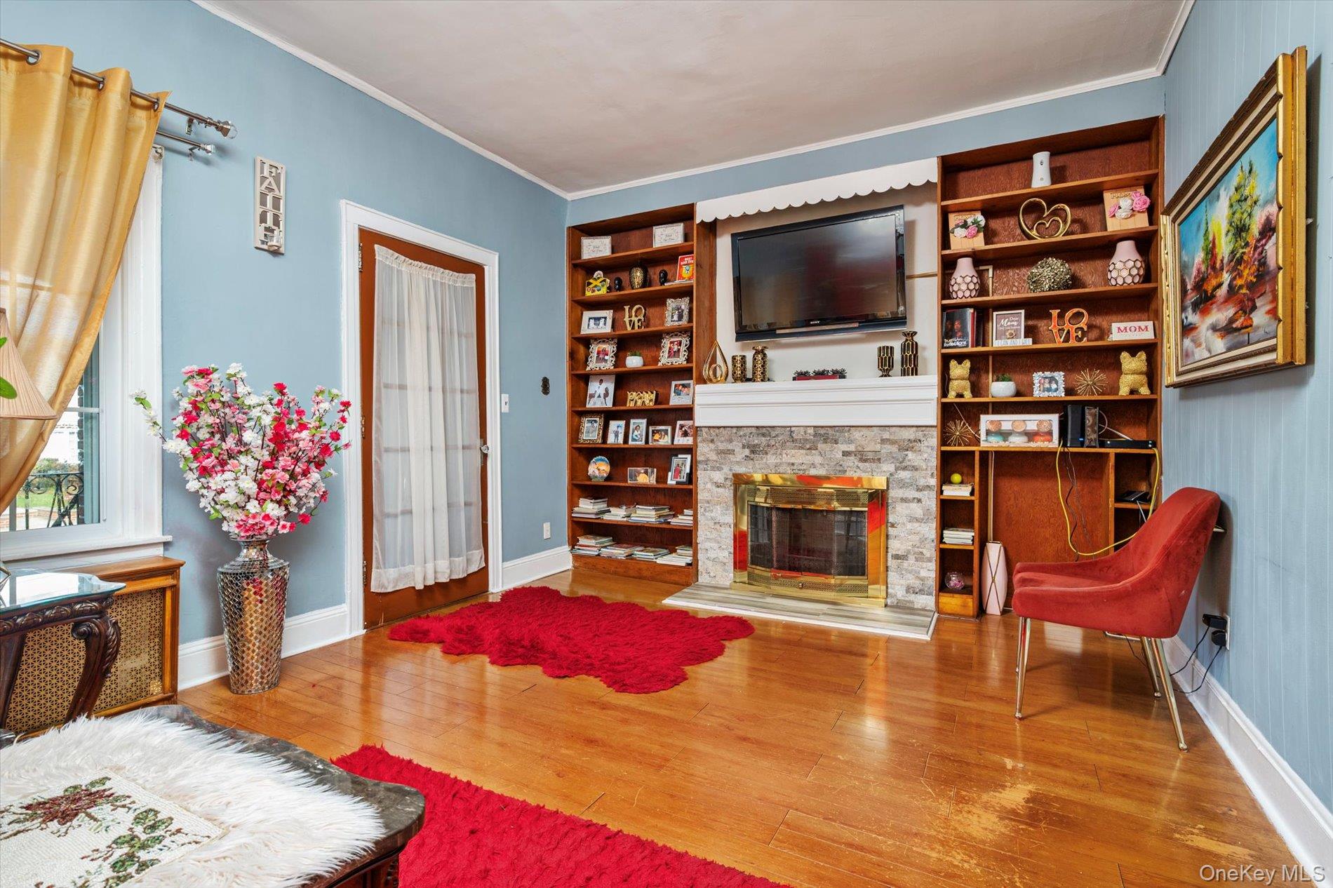 133-15 231st Street Queens, NY 11413 - Photo 6 of 22 a living room with fireplace furniture and a flat screen tv
