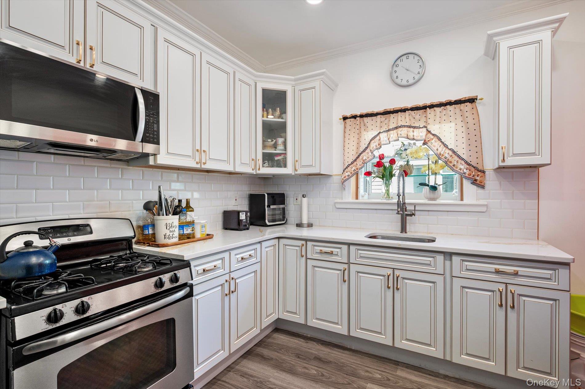 133-15 231st Street Queens, NY 11413 - Photo 7 of 22 a kitchen with stainless steel appliances granite countertop a sink and a stove