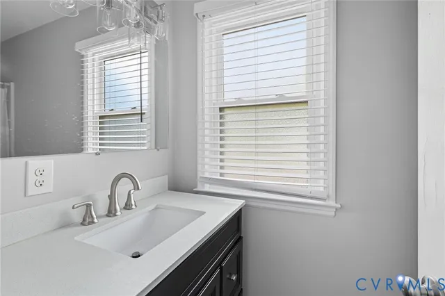 a bathroom with a sink and a window