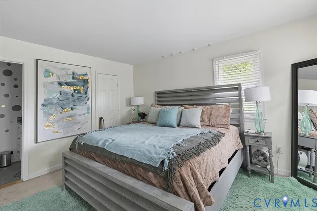 a bedroom with a bed and a painting on the wall