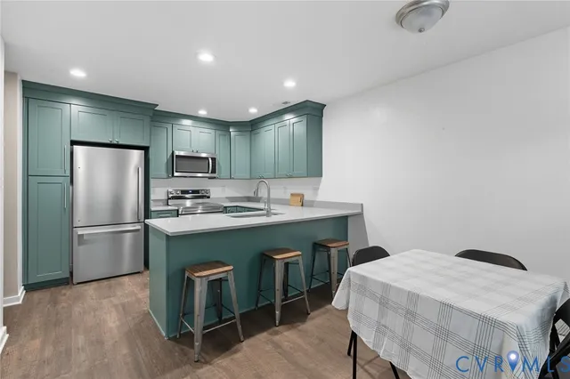 a kitchen with kitchen island a appliances a sink and a refrigerator