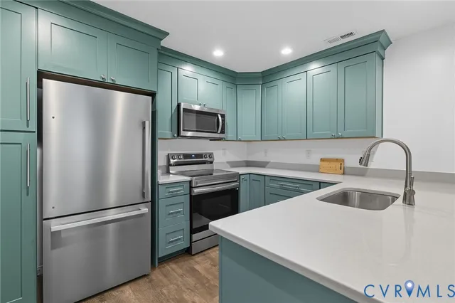 a kitchen with stainless steel appliances a refrigerator and a sink