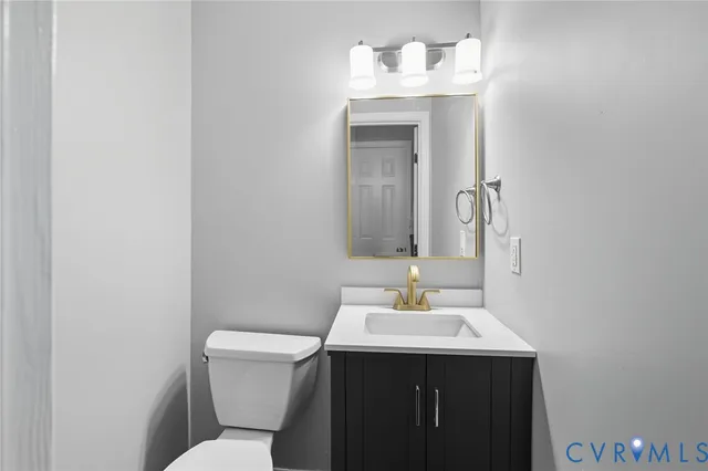 a bathroom with a sink toilet and mirror