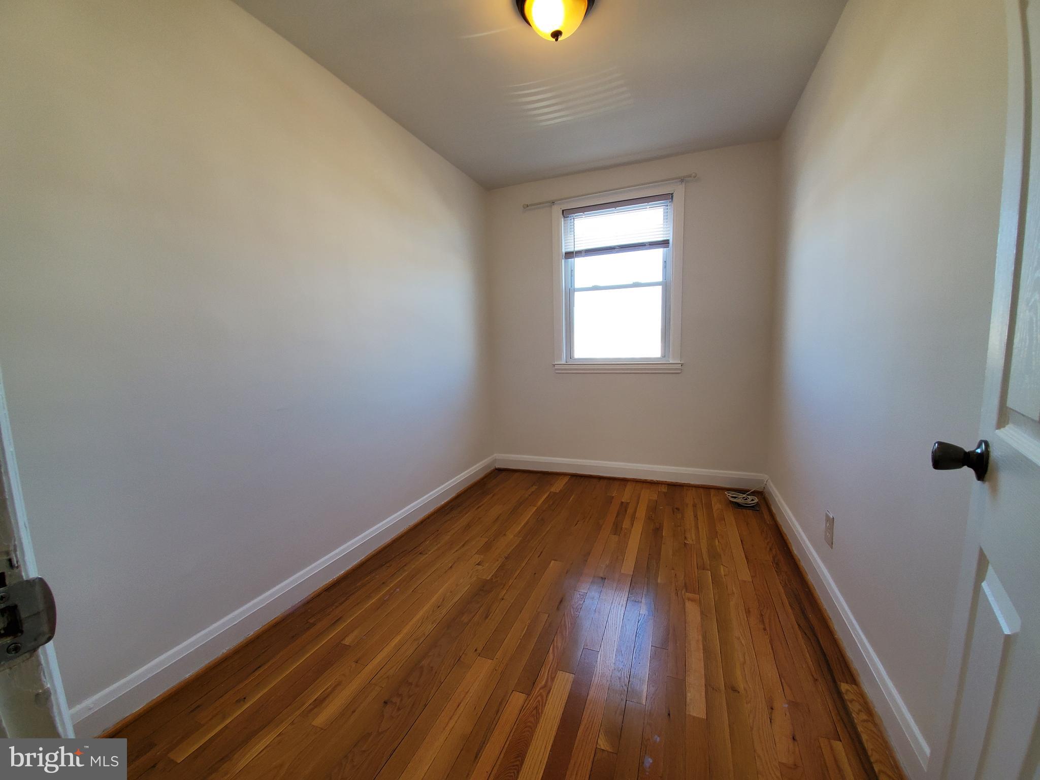 309 Arden Road West Baltimore, MD 21225 - Photo 12 of 16 a view of a room with wooden floor and window
