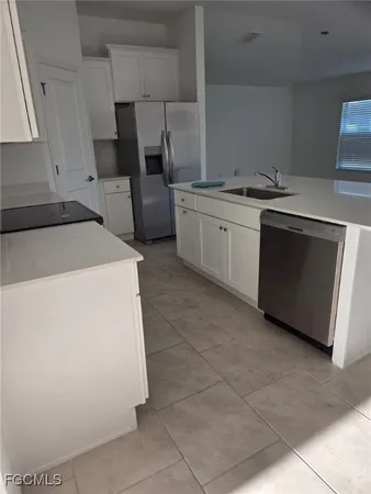 a kitchen with a stove top oven and cabinets