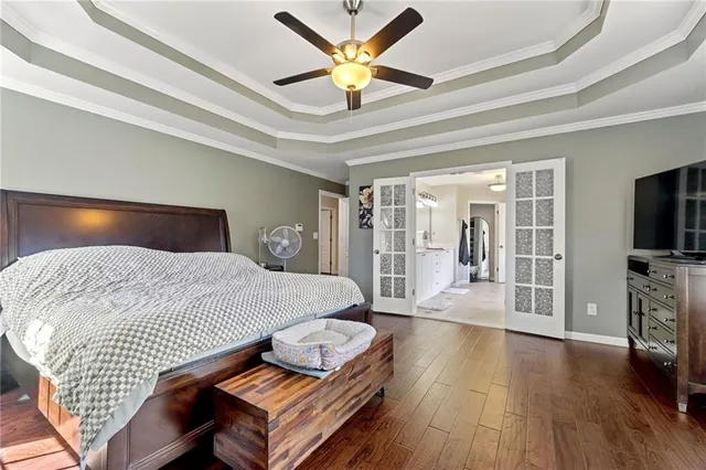 a bedroom with furniture and a chandelier