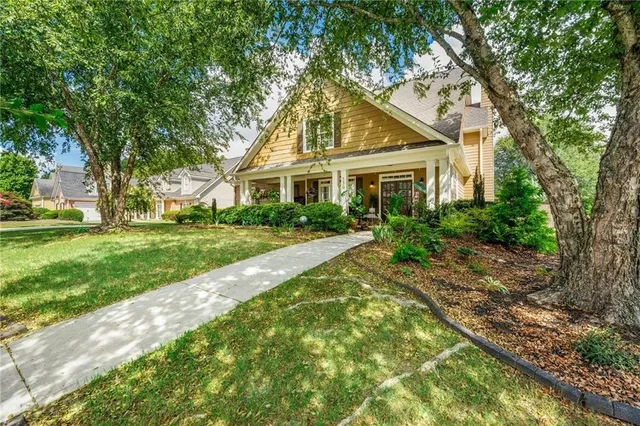 a front view of house with yard and green space