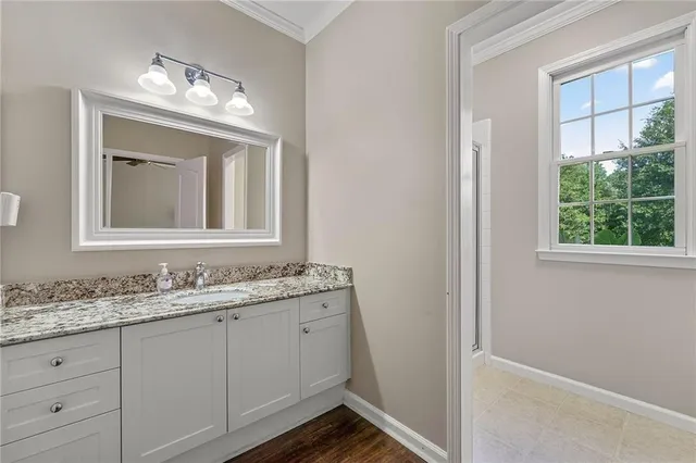 a bathroom with a double vanity sink and a mirror