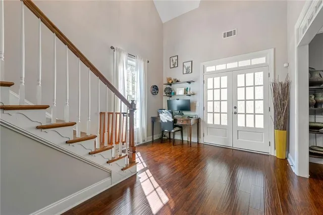 a view of an entryway with wooden floor and door