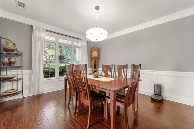 a view of a dining room with furniture window and wooden floor