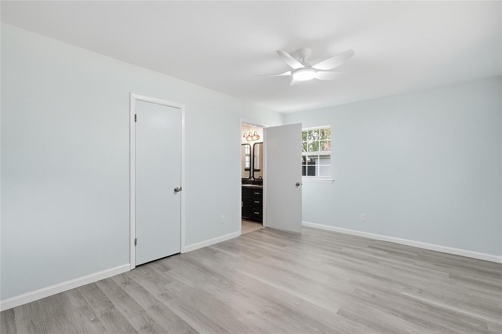 837 Springdale Road Bedford, TX 76021 - Photo 20 of 28 Spacious room featuring wood-finish flooring, light blue walls, and a white ceiling fan