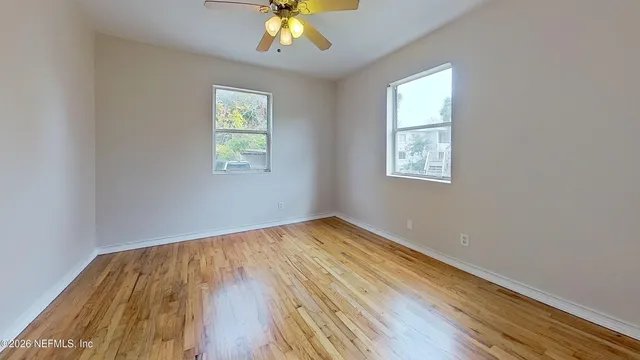 wooden floor in an empty room with a window