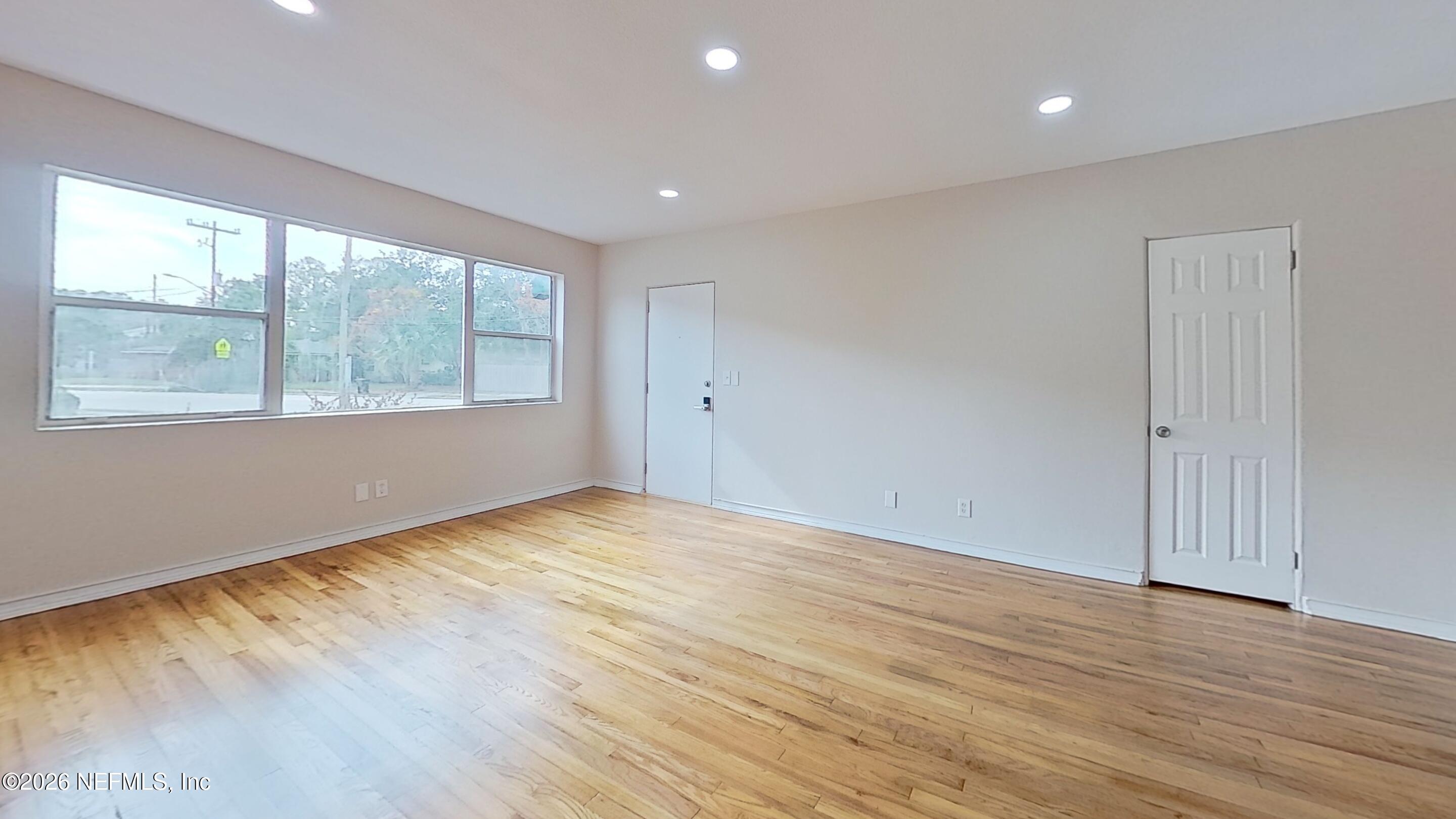 3005 Walton Street, Unit 2 Jacksonville, FL 32207 - Photo 3 of 13 an empty room with wooden floor and windows