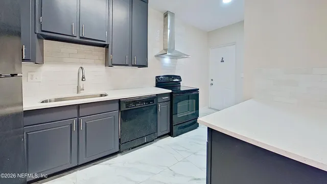 a kitchen with a sink dishwasher and cabinets