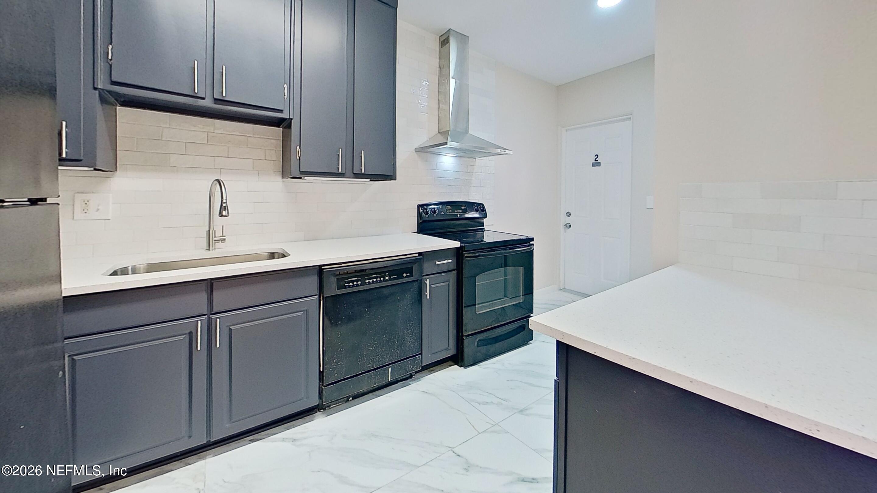 3005 Walton Street, Unit 2 Jacksonville, FL 32207 - Photo 5 of 13 a kitchen with a sink dishwasher and cabinets