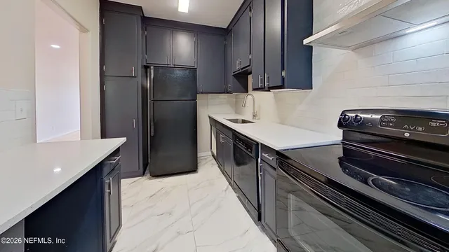 a kitchen with a refrigerator and a sink