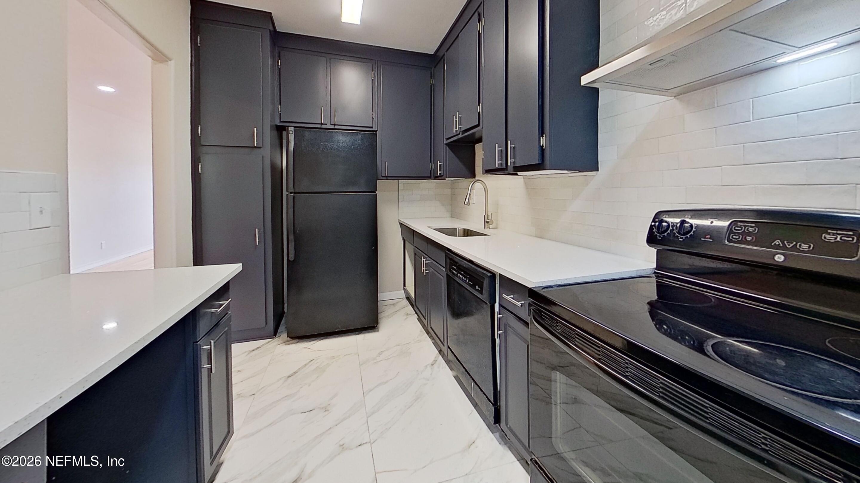 3005 Walton Street, Unit 2 Jacksonville, FL 32207 - Photo 6 of 13 a kitchen with a refrigerator and a sink
