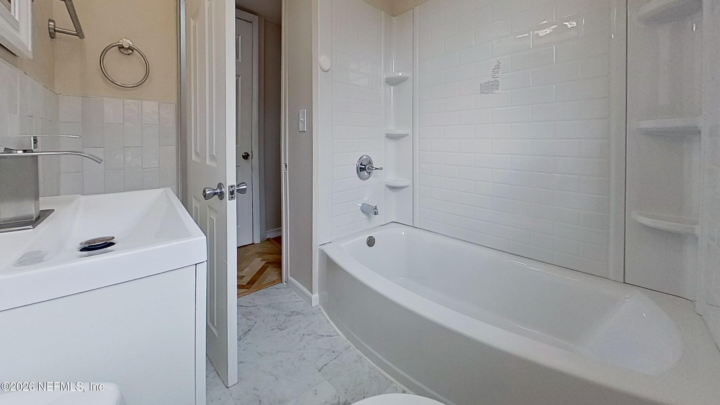 3005 Walton Street, Unit 2 Jacksonville, FL 32207 - Photo 9 of 13 a bathroom with a tub a sink and a shower