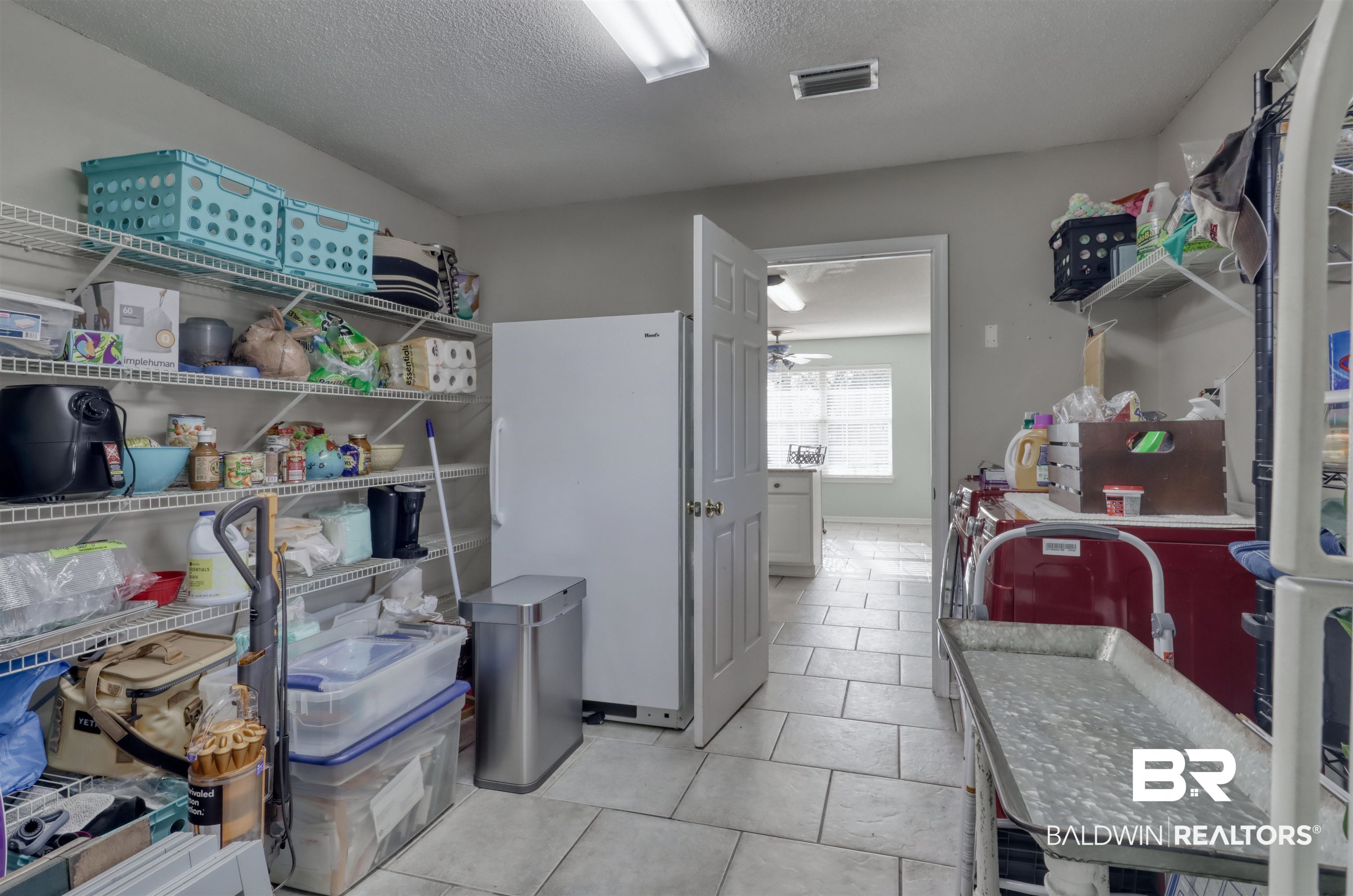 12893 Hunters Chase Foley, AL 36535 - Photo 35 of 42 Kitchen with a textured ceiling, visible vents, ceiling fan, light tile patterned floors, and freestanding refrigerator