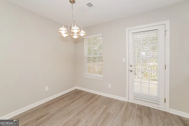 a kitchen with stainless steel appliances granite countertop a sink cabinets and wooden floor