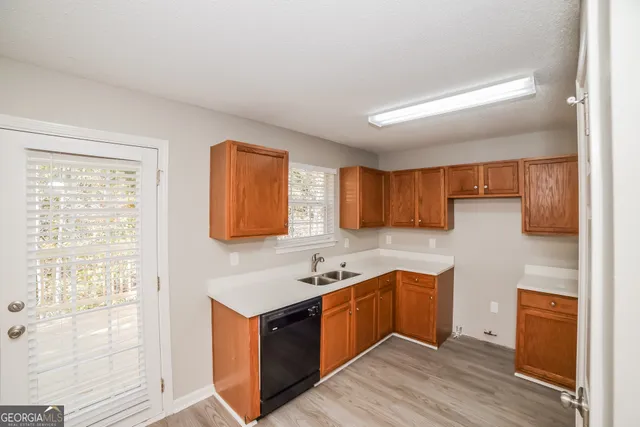 a kitchen with stainless steel appliances granite countertop a sink a stove and a refrigerator