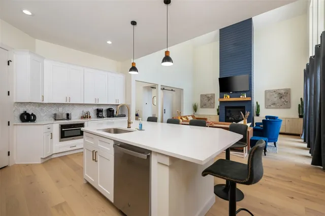 a kitchen with stainless steel appliances granite countertop white cabinets sink and dishwasher