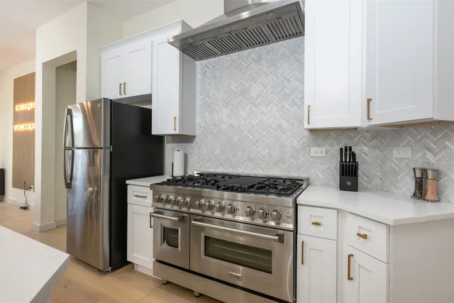 a living room with patio furniture and a potted plants