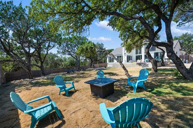a backyard of a house with table and chairs
